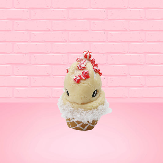 Cute kawaii bunny Peppermint Bark white ice cream with peppermint pieces and a peppermint candy on top of the bunny near the whipped cream swirl. This view is from the front.