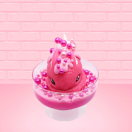 Cute kawaii bunny Bubbles pink ice cream sundae with light pink drizzle, pink and hot pink metallic spheres inside the dish. The bunny’s top is covered with the pink and hot pink spheres as well as a swirl of whipped cream. This view is from the front.