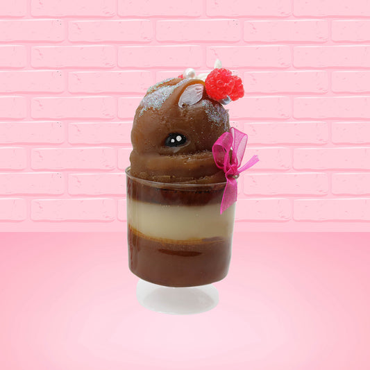 Cute kawaii bunny tall brown Hot Fudge ice cream sundae with glitter and raspberries on top with the whipped cream swirl. The bunny has white pearls and a pink ribbon. This view is from the side.