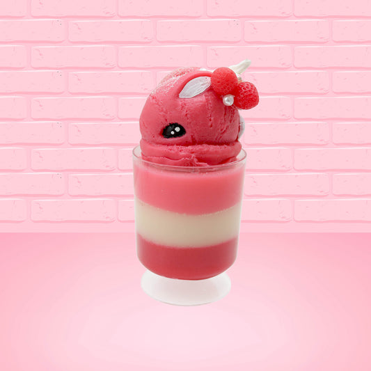 Cute kawaii bunny tall Strawberry Parfait Sundae red ice cream with strawberries, a pearl, and a whipped cream swirl on the top of the bunny. This view is from the side.