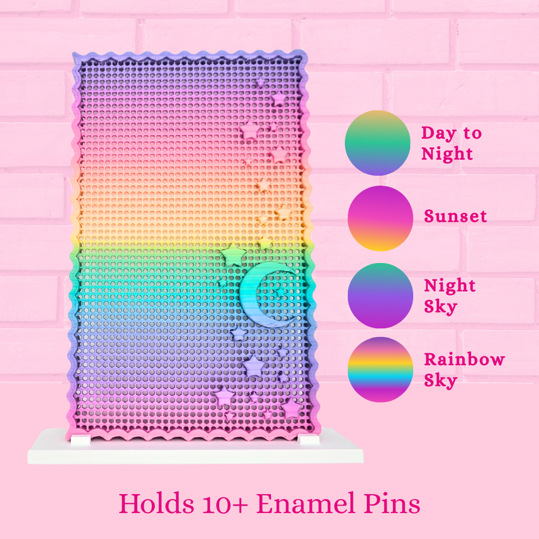 Moon and Star display board varieties are shown, Day to night, Sunset, Night Sky, and Rainbow Sky and the words Holds 10+ enamel pins.