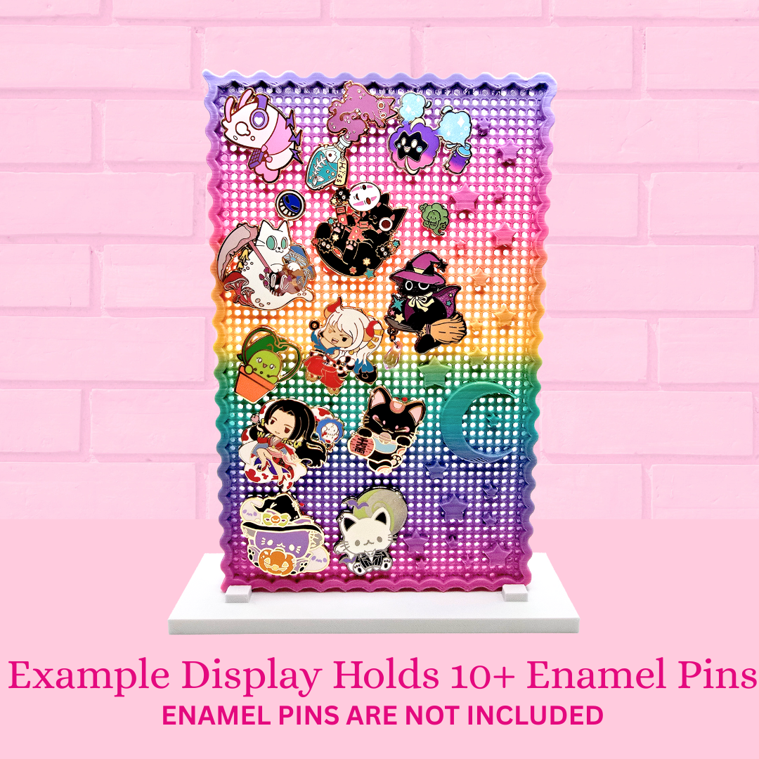 Rainbow sky enamel pin board with 13 enamel pins, with the words Example display holds 10+ enamel pins, Enamel pins are not included.