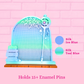 A pastel-colored enamel pin display stand with a pink brick wall background. The stand features a teal and light blue arched frame with a wire grid, a small fan at the top, and a wooden base.