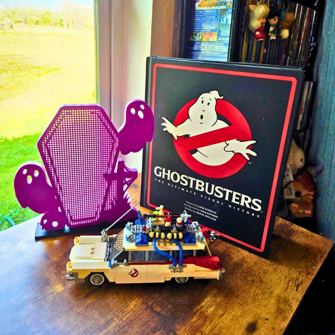 Example display Ghost Coffin with Skull/Cross on a desk, with a brick built car, and a large book near the display. 