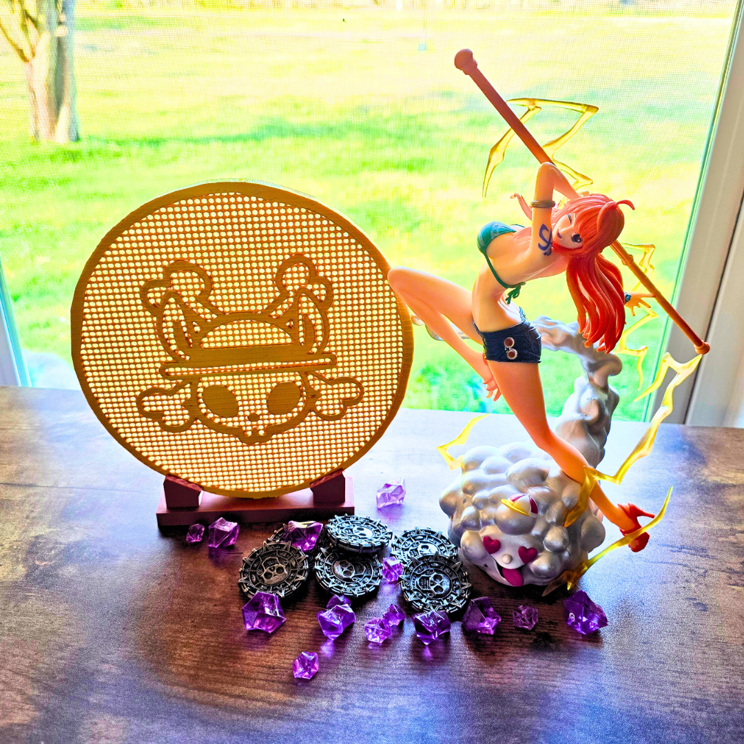 Gold pirate bunny coin enamel pin display board next to some pirate coins, purple gems, and an anime girl figure on top of a cloud, on top of a desk.