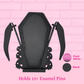 Black coffin-shaped pin holder with skull details and two curved wing-like side supports, shown against a pink brick background with color swatches labeled Pink/White and Black, and text stating it holds 13+ enamel pins.