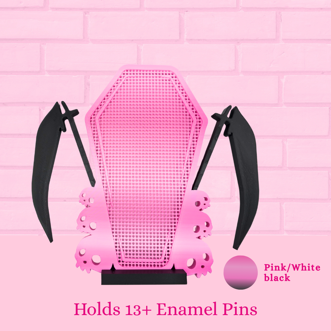 Pink and white, black Scythe Coffin with Skulls enamel pin board, with the words Holds 13+ enamel pins.