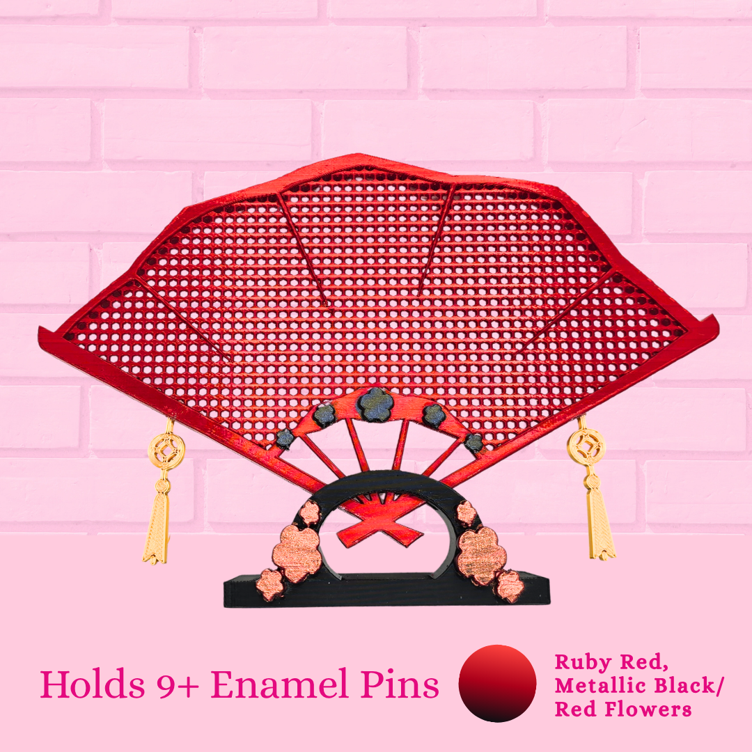 Ruby Red Japanese fan close up with the words holds 9+ enamel pins.