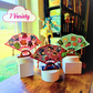 Different 3 colored fans with enamel pins on them, on top of a desk in a room with a blue haired anime girl figure and the words 7 Variety in a cloud, Example display holds 9+ Enamel Pins, Enamel Pins are not included.