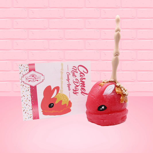 Cute kawaii red bunny with caramel drizzle and nuts with a boney finger stick.  The front of the character card and scented are shown.
