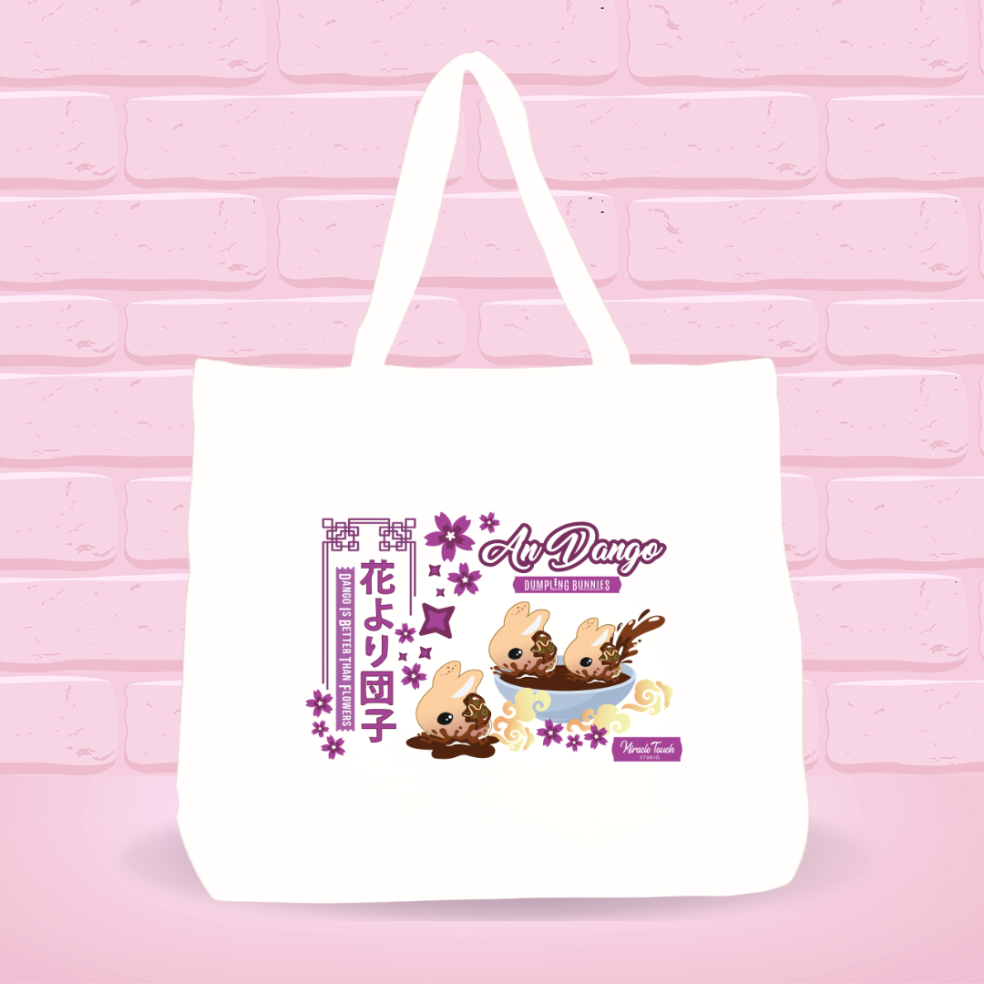 White tote bag with An Dango Dumplings and text on a pink brick wall background