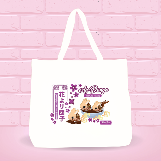White tote bag with An Dango Dumplings and text on a pink brick wall background