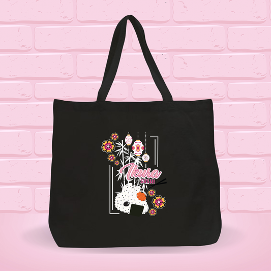 A black canvas tote bag with the Ikura Sushi Bunny Design on it.