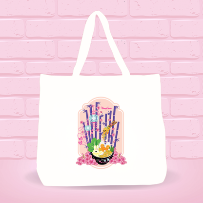 White tote bag with Kong Fu Tofu Heaven Ramen Bunny bowl design on a pink brick wall background.