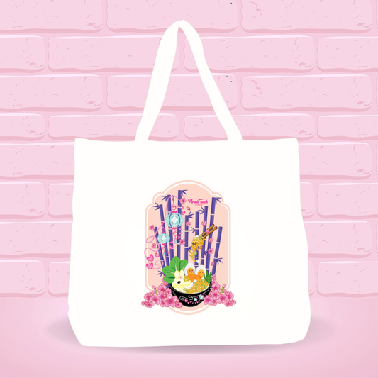 White tote bag with Kong Fu Tofu Heaven Ramen Bunny bowl design on a pink brick wall background.