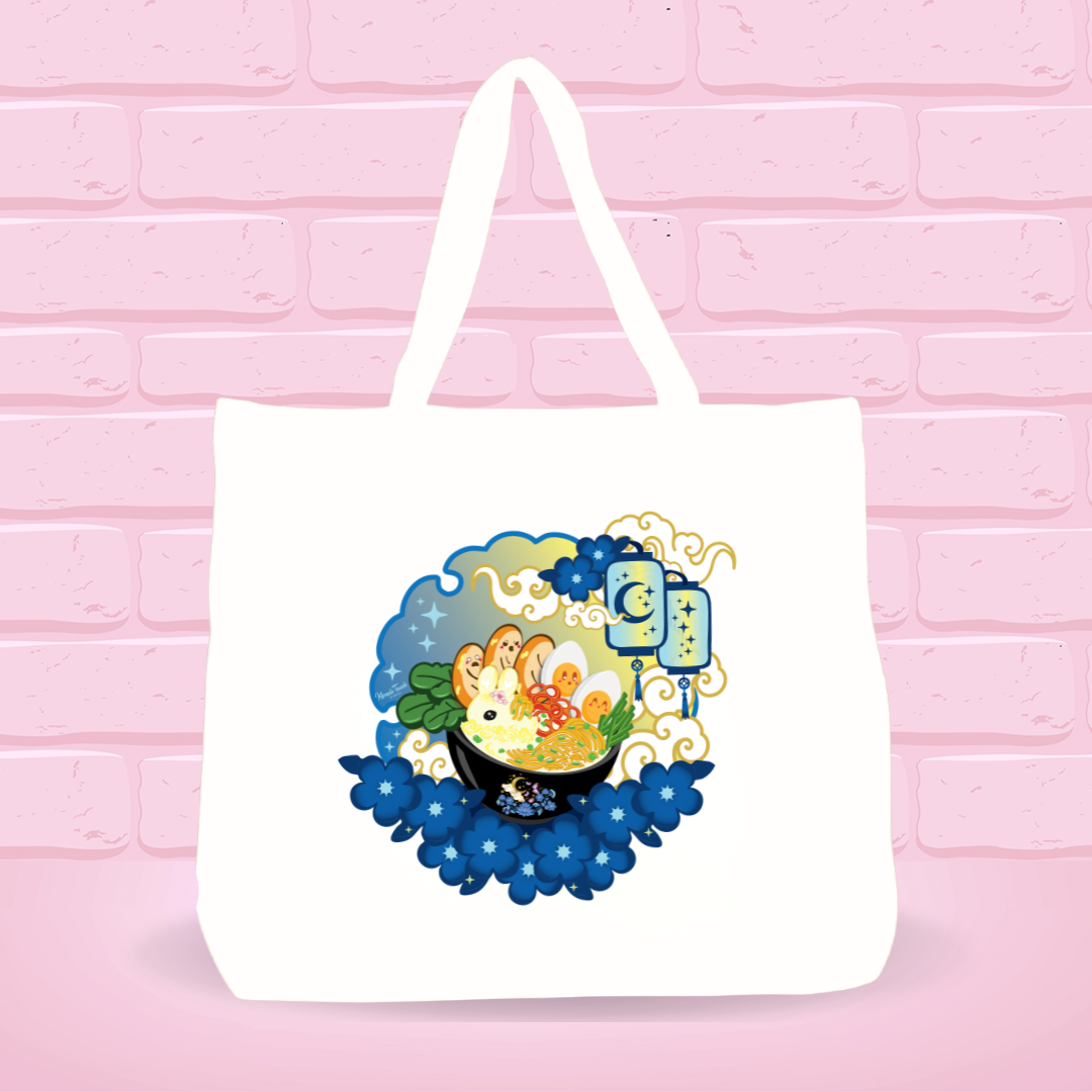 White tote bag with Moonlight Delight Ramen Bunny bowl nightly scenery design on a pink brick wall background.
