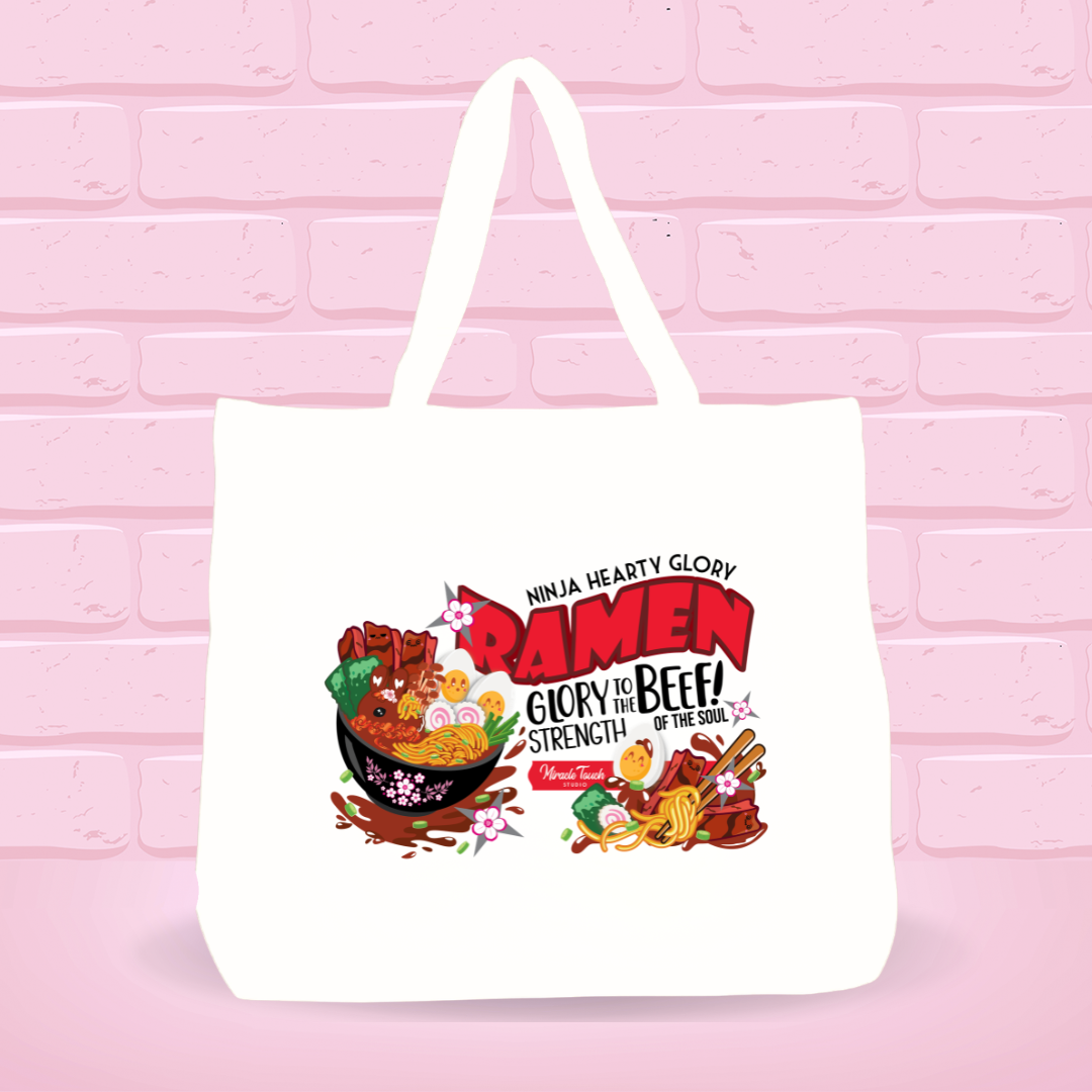 White tote bag with Ninja Hearty Glory Bunny bowl design and inspire quote text on a pink brick wall background.