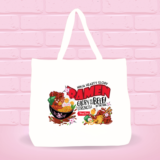White tote bag with Ninja Hearty Glory Bunny bowl design and inspire quote text on a pink brick wall background.