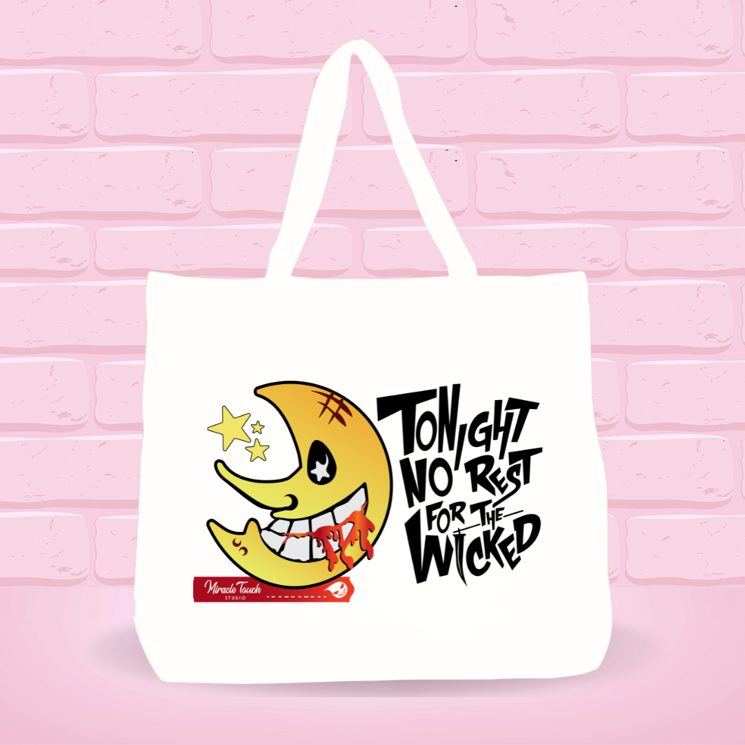 White tote bag with Soul E. Moon for the  Wicked design and  text on a pink brick wall background