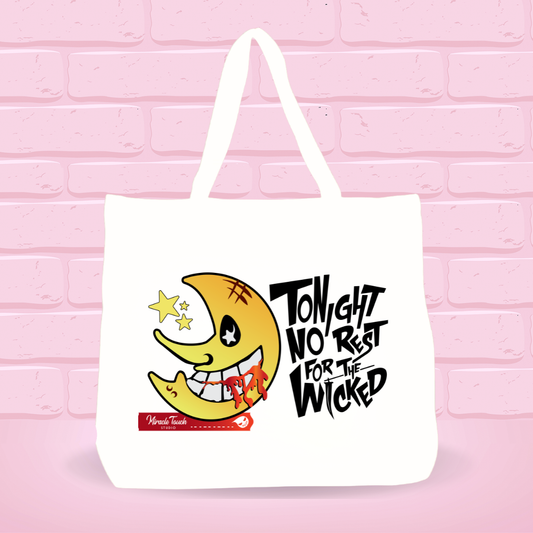 White tote bag with Soul E. Moon for the  Wicked design and  text on a pink brick wall background