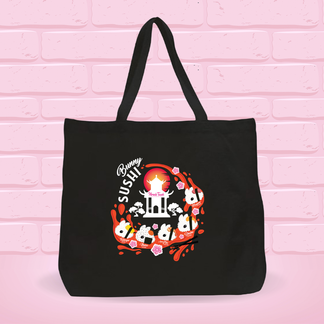 Black tote bag with a 'New Bunny Sushi set' design on a pink brick wall background