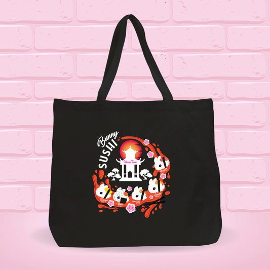 Black tote bag with a 'New Bunny Sushi set' design on a pink brick wall background