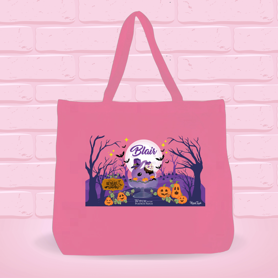 A pink canvas tote bag with the Blair Bunny Design on it, which has Beware witches, Witch in the Pumpkin Patch on it. 