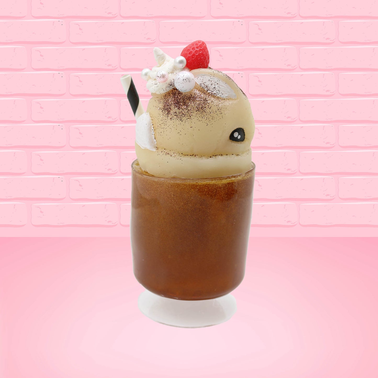 Cute kawaii bunny Root Beer Float white bunny in a brown drink with a black and white straw on the side. The bunny has a strawberry, brown glitter, silver pearls, on top next to the swirl of whipped cream. This view is from the other side.