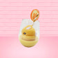 Cute kawaii bunny Screwdriver orange drink inside a glass with a gold white straw with an orange slice and orange flower on the rim of the glass. The view is from the side.