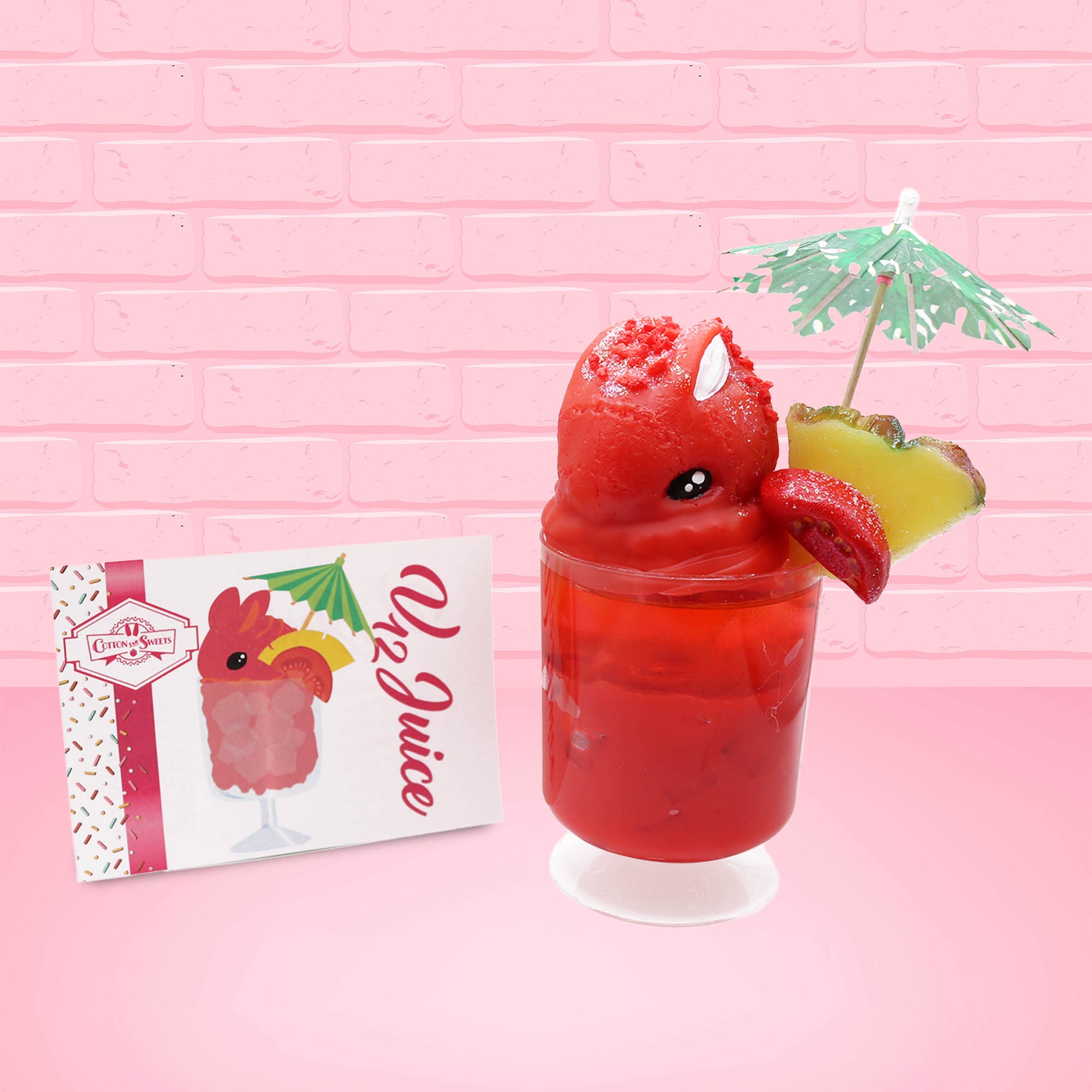 Cute kawaii bunny V12 red drink with red bits and white glitter on top of the bunny. A green palm tree umbrella with a pineapple slice and tomato slice on the rim of the drink on the side. The front of the character card is shown as well.
