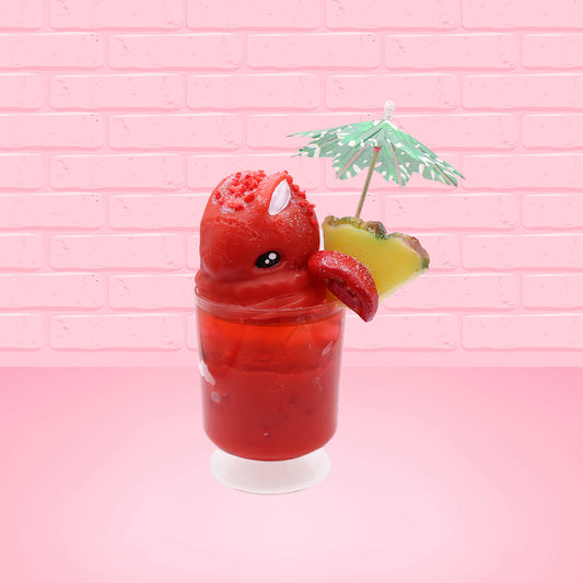 Cute kawaii bunny V12 red drink with red bits and white glitter on top of the bunny. A green palm tree umbrella with a pineapple slice and tomato slice on the rim of the drink on the side. This view is from the front at an angle.