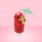 Cute kawaii bunny V12 red drink with red bits and white glitter on top of the bunny. A green palm tree umbrella with a pineapple slice and tomato slice on the rim of the drink on the side. This view is from the side.