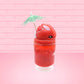 Cute kawaii bunny V12 red drink with red bits and white glitter on top of the bunny. A green palm tree umbrella with a pineapple slice and tomato slice on the rim of the drink on the side. This view is from the other side.
