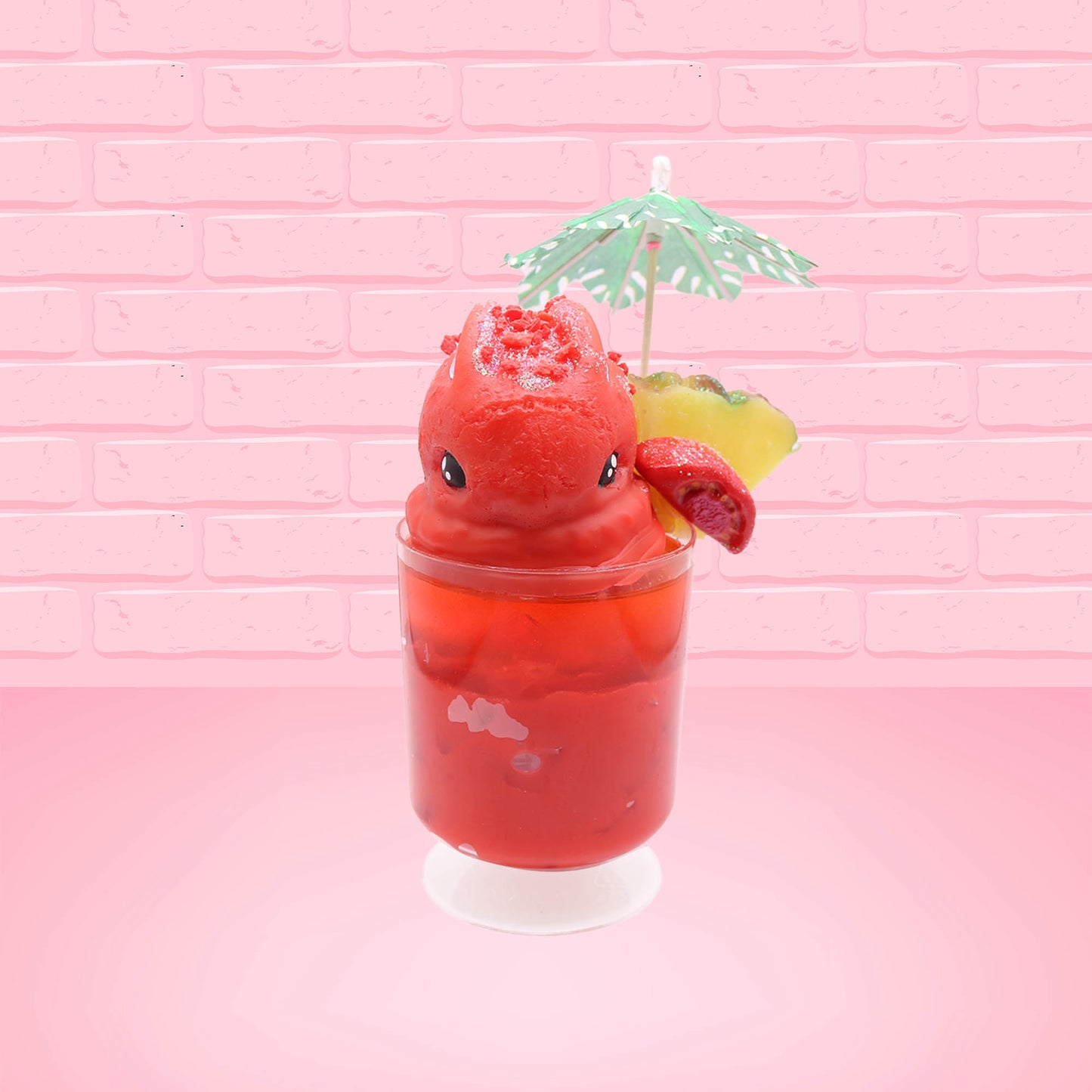 Cute kawaii bunny V12 red drink with red bits and white glitter on top of the bunny. A green palm tree umbrella with a pineapple slice and tomato slice on the rim of the drink on the side. This view is from the front.