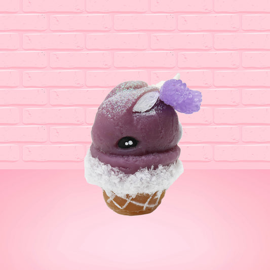 Cute kawaii bunny Blackberry Cobbler Dazzle with white glitter and purple raspberries on top near the swirl of whipped cream. This view is from the side.
