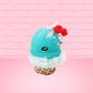 Cute bunny kawaii Blue Razz Star Blast blue ice cream with red raspberries, silver pearls and clear stars on the top of the bunny near the whipped cream swirl. This view is from the side.
