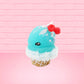 Cute bunny kawaii Blue Razz Star Blast blue ice cream with red raspberries, silver pearls and clear stars on the top of the bunny near the whipped cream swirl. This view is from the side at a different angle.