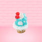 Cute bunny kawaii Blue Razz Star Blast blue ice cream with red raspberries, silver pearls and clear stars on the top of the bunny near the whipped cream swirl. This view is from the back.