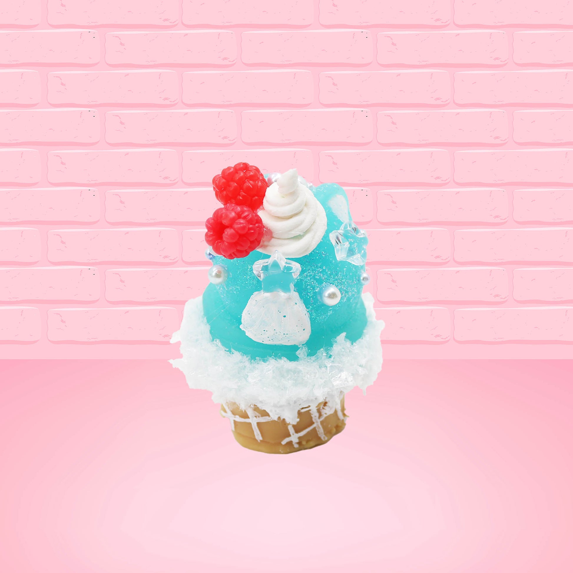 Cute bunny kawaii Blue Razz Star Blast blue ice cream with red raspberries, silver pearls and clear stars on the top of the bunny near the whipped cream swirl. This view is from the back.
