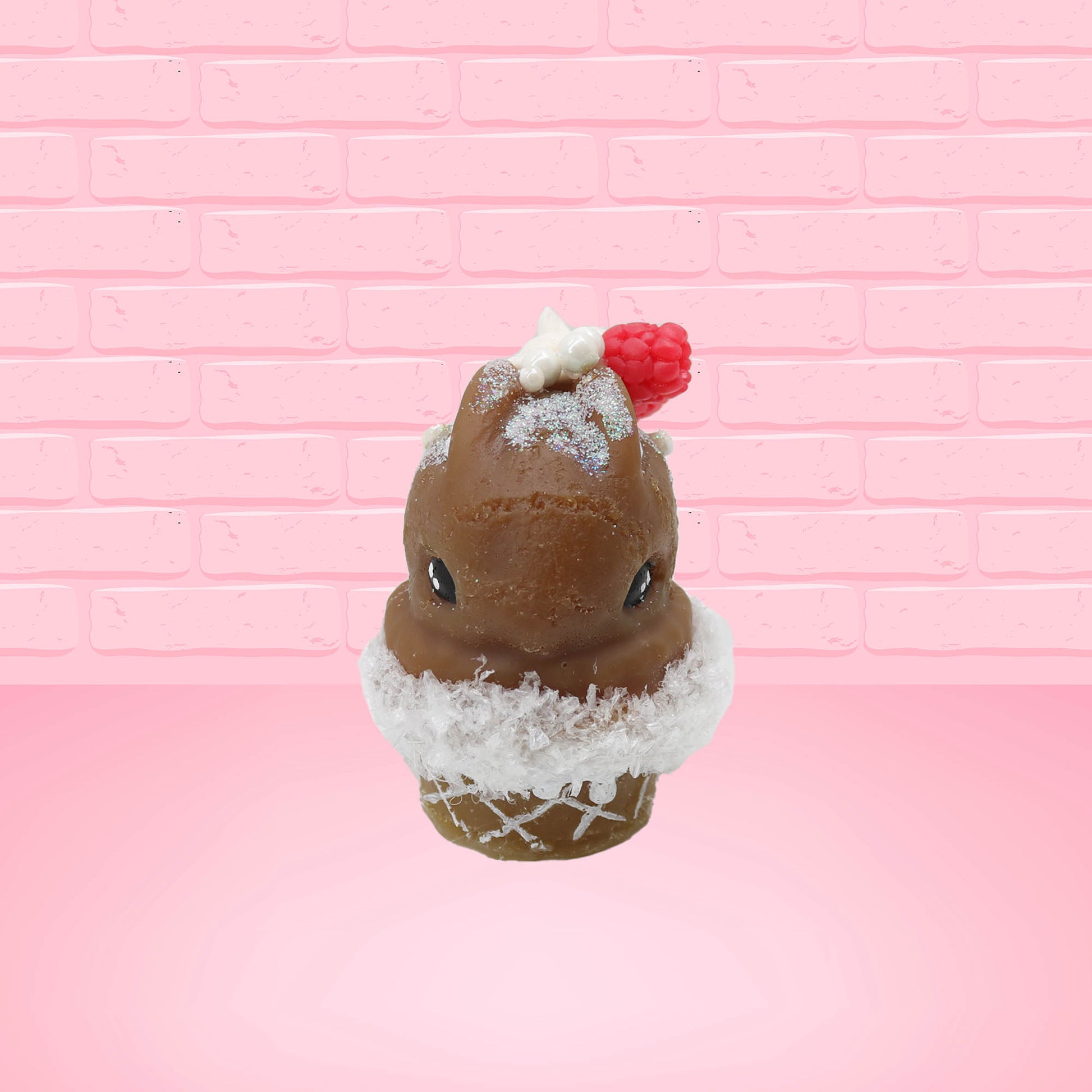 Cute kawaii bunny chocolate ice cream cone with glitter and red raspberries on top of the bunny near the swirl of whipped cream. This view is from the front.