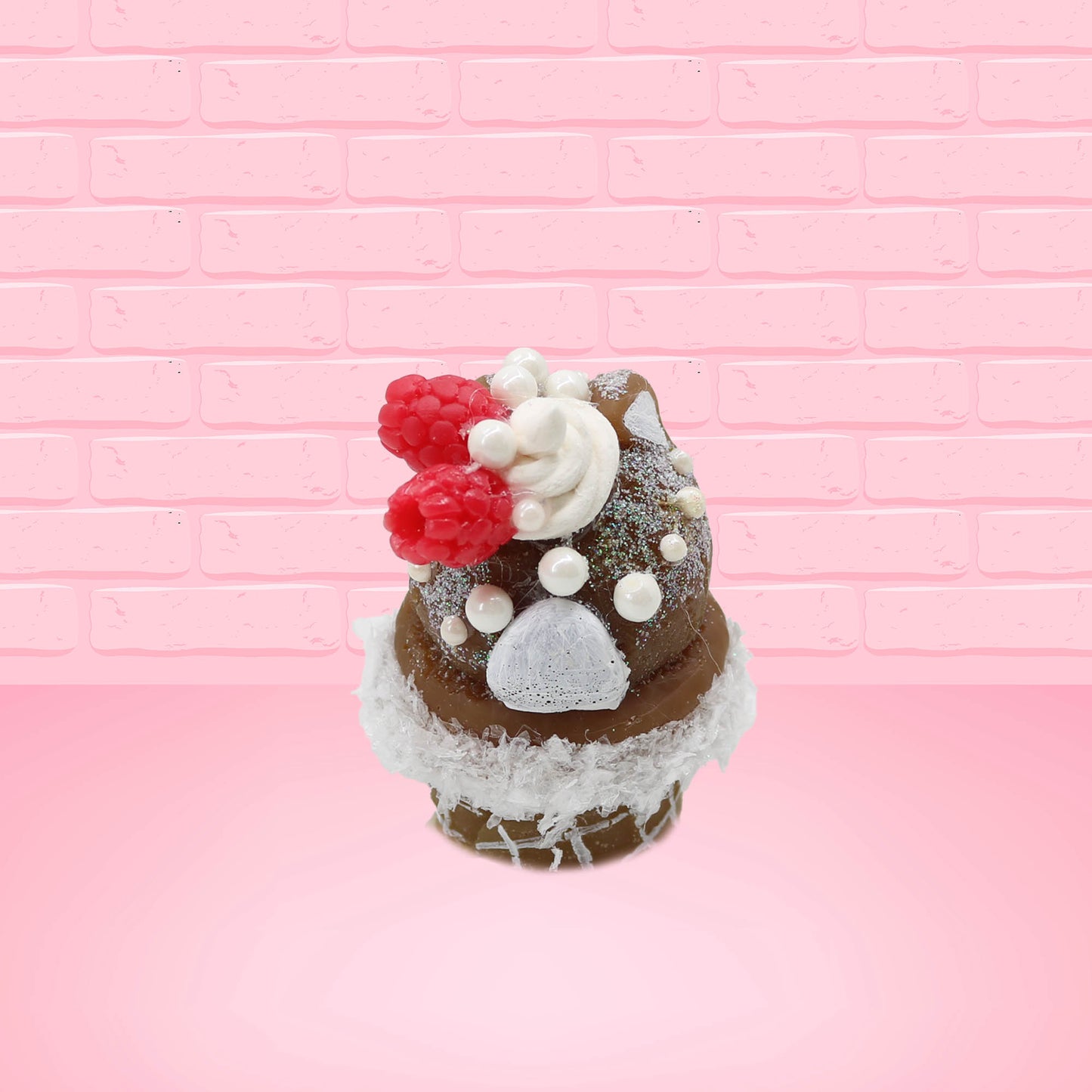 Cute kawaii bunny chocolate ice cream cone with glitter and red raspberries on top of the bunny near the swirl of whipped cream. This view is from the back.