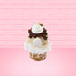 Cute kawaii bunny Cookie Dough ice cream cone with chocolate pieces and drizzle on top of the bunny as well as a cookie near the whipped cream swirl. This view is from the back.