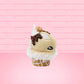 Cute kawaii bunny Cookie Dough ice cream cone with chocolate pieces and drizzle on top of the bunny as well as a cookie near the whipped cream swirl. This view is from the other side.