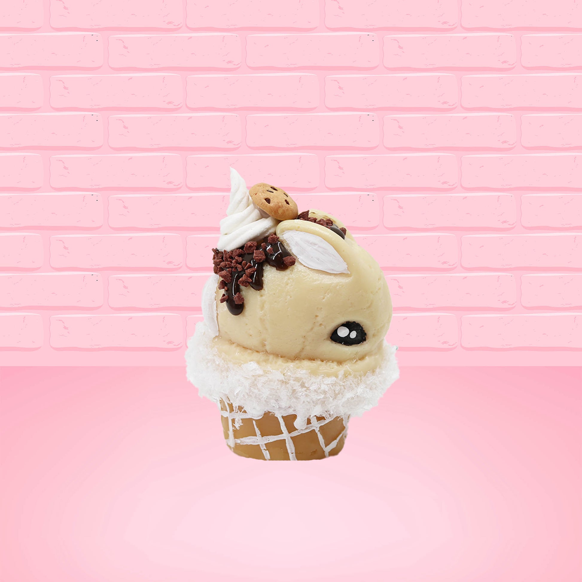 Cute kawaii bunny Cookie Dough ice cream cone with chocolate pieces and drizzle on top of the bunny as well as a cookie near the whipped cream swirl. This view is from the other side.