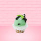 Cute kawaii bunny mint chocolate green ice cream cone with chocolate drizzle and sprinkles near the swirl of the whipped cream, with green mint leaves.  The view is from the side.
