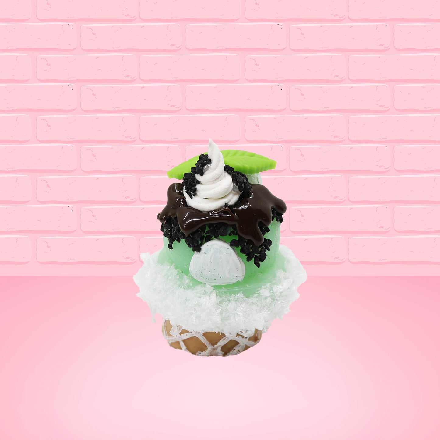 Cute kawaii bunny mint chocolate green ice cream cone with chocolate drizzle and sprinkles near the swirl of the whipped cream, with green mint leaves.  The view is from the back.