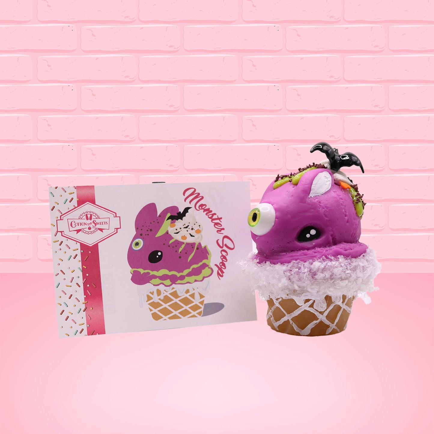 Cute kawaii bunny Monster Scoop purple ice cream cone with a green eye in the center, green drizzle with chocolate bits, pumpkin and bat sprinkles, and a bat on the top of the bunny near the whipped cream swirl. The front of the character card is shown as well.
