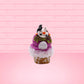 Cute kawaii bunny Monster Scoop purple ice cream cone with a green eye in the center, green drizzle with chocolate bits, pumpkin and bat sprinkles, and a bat on the top of the bunny near the whipped cream swirl. This view is from the back.