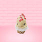 Cute kawaii bunny Peppermint Bark white ice cream with peppermint pieces and a peppermint candy on top of the bunny near the whipped cream swirl. This view is from the front.