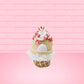 Cute kawaii bunny Peppermint Bark white ice cream with peppermint pieces and a peppermint candy on top of the bunny near the whipped cream swirl. This view is from the back.